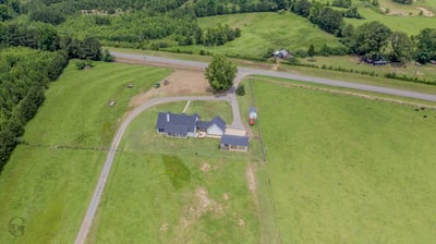 Sprawling property with ample green space, featuring a spacious home and easy road access for convenience.