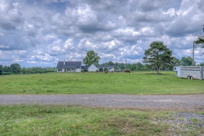 Rural property featuring house, open fields, and stunning countryside views, ideal for farming or relaxation.