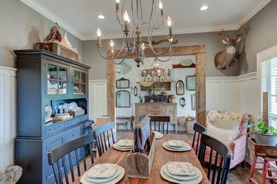 This inviting dining room features a rustic design with unique decor and spacious seating for gatherings.