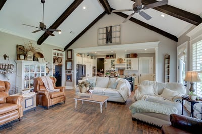 Spacious living area features high ceilings, cozy seating, and an open layout ideal for entertaining.