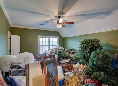 Spacious room ideal for storage or transformation, featuring vaulted ceilings and ample natural light.