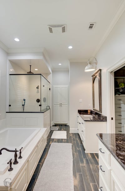 Bright and spacious bathroom featuring modern fixtures, a luxurious soaking tub, and sleek tile flooring.