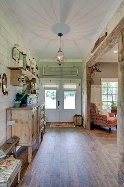 Welcome to a warm entryway featuring modern finishes, natural light, and inviting rustic elements throughout.