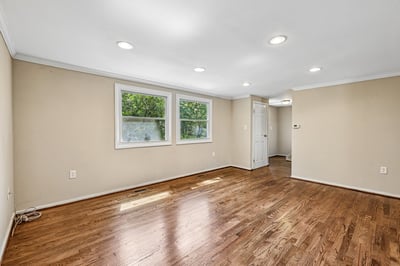 Spacious living area with ample natural light and newly refinished hardwood floors throughout. Perfect for customization!