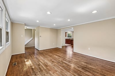 Spacious living area featuring hardwood floors, ample natural light, and an inviting open layout to the kitchen.