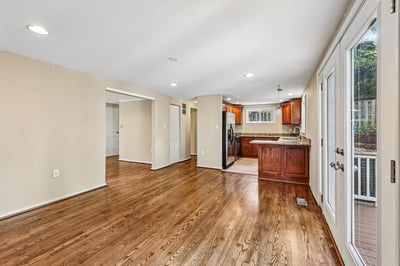 Spacious open layout featuring warm hardwood floors and a modern kitchen, perfect for entertaining.