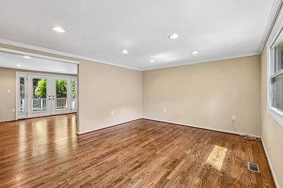 Bright, versatile space with hardwood floors, ideal for creative design and comfortable living.