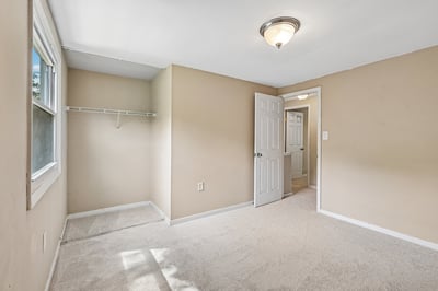 This versatile room features ample natural light, soft carpeting, and convenient access to nearby amenities.