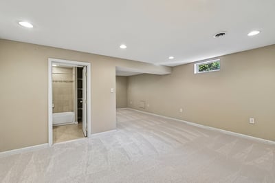 Spacious basement offering versatile living space with natural light and a convenient attached bathroom.