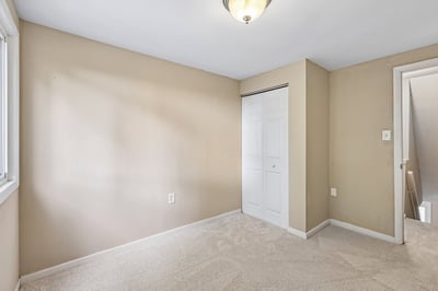 Bright, versatile room with ample natural light and built-in storage, ready for your personal touch.