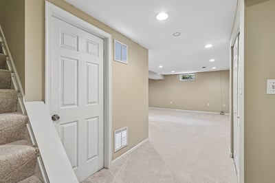 Spacious basement area featuring neutral colors, versatile layout, and abundant natural light for various uses.
