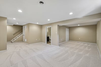 Spacious, versatile basement with neutral tones, perfect for a media room or additional living area.