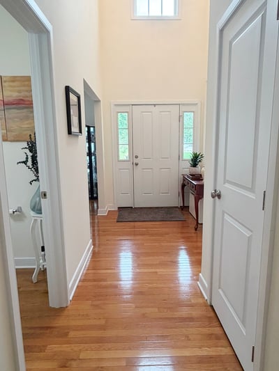 Front Hallway w/ Half Bath, Coat Closet, and Stairway to Bsmt