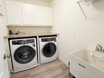 2nd Fl Laundry Rm w/ Utility Sink & Built-in Shelf & Cabinets. Electrolux W/D Included