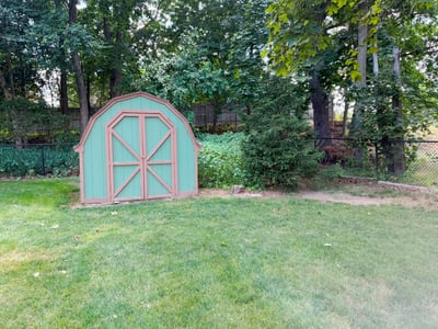 One of 2 Sheds Added by Seller. Seller also installed the fence in 2015: wood privacy fencing along the sides and chain link fencing beyond that with a gate along the back fence line