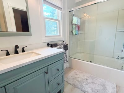Full Bath w/ fiberglass tub/shower w/ updated glass sliding doors
