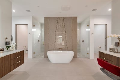 Contemporary Paradise Valley bathroom featuring a freestanding soaking tub, dual vanities, and elegant marble feature wall. Designed for relaxation, this space delivers spa-inspired luxury and modern finishes.