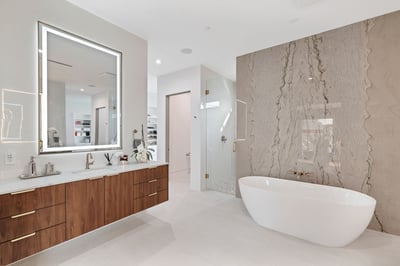 Sleek bathroom with freestanding tub, custom vanity, and glass shower enclosure. This Paradise Valley home showcases luxury upgrades and spa-inspired design elements.
