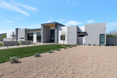 Exterior angle highlighting the home s modern design, large windows, and structured lines. This Paradise Valley property combines luxury finishes with desert-friendly landscaping.