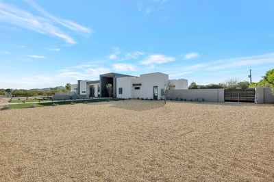Clean and modern north-facing fa ade with gated entry and privacy wall. This Paradise Valley home offers security, sleek design, and a spacious setting.