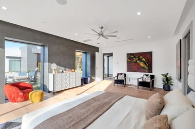 Bright and open primary bedroom with modern finishes and large windows. This Paradise Valley home offers a relaxing retreat with natural light and contemporary design.