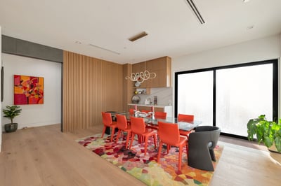 Dining space with bold design elements, modern lighting, and sliding glass doors. This Paradise Valley home creates an inviting area for gatherings and everyday dining.