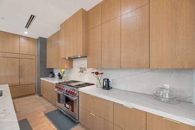 Contemporary kitchen with custom wood cabinetry, quartz surfaces, and high-end appliances. This Paradise Valley home delivers style, storage, and functionality.