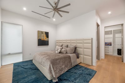 Spacious bedroom with modern flooring, soft natural light, and convenient closet access. This Paradise Valley home offers flexible and functional living spaces