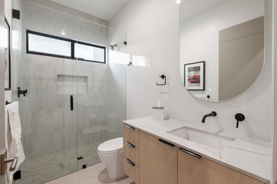 Updated bathroom with glass shower, modern vanity, and clean finishes. This Paradise Valley home features stylish upgrades throughout.