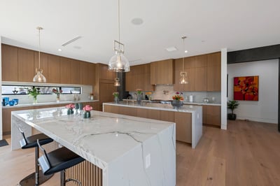 High-end kitchen with large island, quartz counters, and custom cabinetry. This Paradise Valley home is designed for entertaining and modern living.