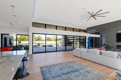 Large great room combining living, kitchen, and dining areas with modern finishes and high ceilings. This Paradise Valley home features a desirable open floor plan.