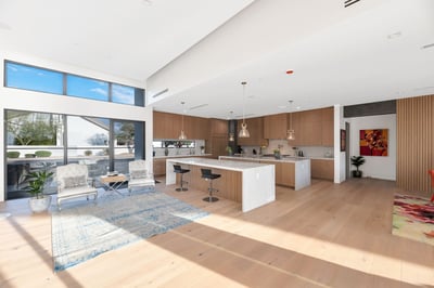 Spacious living room with high ceilings and seamless transition to kitchen and dining spaces. This Paradise Valley home is designed for entertaining and everyday comfort.
