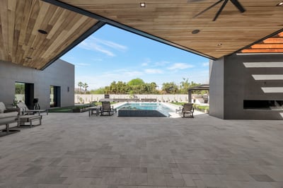 Open patio flowing into a sleek pool and landscaped yard. This Paradise Valley home offers a seamless connection between indoor and outdoor spaces.
