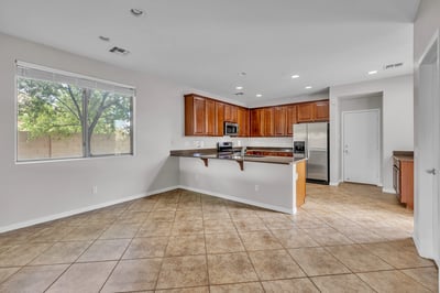 Efficient kitchen design with breakfast bar, stainless appliances, and ample storage ideal for daily living and entertaining.