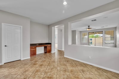 Built-in desk area provides a dedicated workspace, ideal for remote work or study within this well-designed Goodyear home.