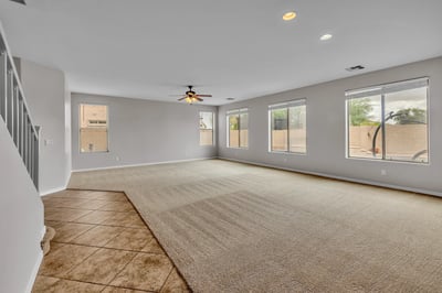 Generous family room with large windows and open flow, offering flexibility for entertaining and everyday comfort.