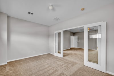 Bonus sitting space off the primary suite with soft carpet and natural light, ideal for a private workspace or quiet relaxation area.