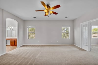 Bright and adaptable bedroom with neutral tones and carpet flooring, offering flexibility for guests, office use, or hobbies.