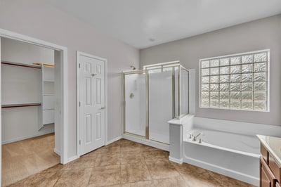 Convenient primary bathroom layout with direct access to a walk-in closet, enhancing everyday functionality and storage.