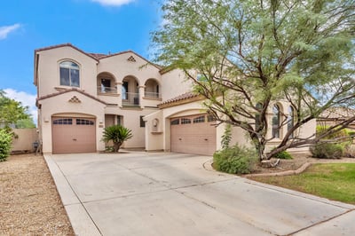 Generous driveway with multiple garage spaces, ideal for extra parking and storage needs in this Goodyear home.