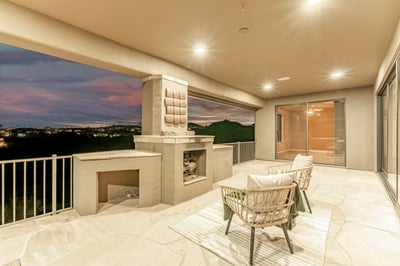 Elegant outdoor retreat showcasing a built-in fireplace, covered seating area, and breathtaking evening skies. This Fountain Hills patio delivers warmth, ambiance, and unforgettable desert views.