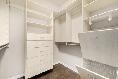 Custom walk-in closet with built-in drawers, shelving, and hanging storage designed to maximize organization. A functional and stylish extension of the primary suite.