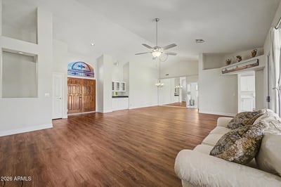 Designed for entertaining and everyday comfort, this spacious great room features soaring ceilings, abundant natural light, and beautiful flooring throughout. The open layout provides endless furniture arrangement possibilities.