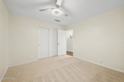 This comfortable bedroom features a ceiling fan, soft carpeting, and generous closet storage. Neutral d cor provides a move-in-ready canvas for a variety of uses and personal styles.