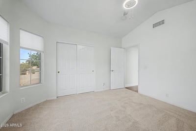 Offering generous dimensions, soft carpeting, and a large closet, this bedroom provides a comfortable and flexible space for family members or guests within this attractive Peoria home.