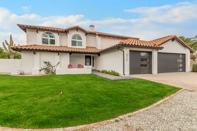 Updated Scottsdale residence featuring refreshed stucco, attractive architectural details, modern garage doors, and manicured landscaping. Exceptional curb appeal highlights the home's extensive improvements.