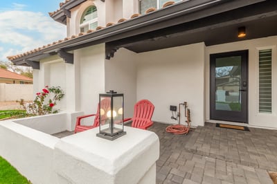 Welcoming front patio with paver finishes, comfortable seating, and a stylish covered entry. This inviting Scottsdale outdoor space blends privacy, charm, and modern updates.