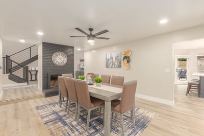 Elegant dining area highlighted by a painted brick fireplace, updated finishes, and open-concept flow. Perfect for entertaining guests in this stylish Scottsdale home.
