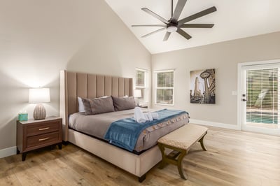 Relaxing primary suite featuring vaulted ceilings, generous dimensions, natural light, and convenient outdoor access. A comfortable Scottsdale sanctuary overlooking the backyard amenities.