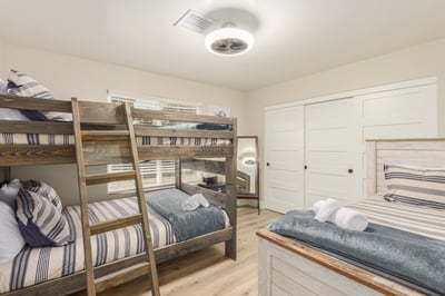 Spacious bedroom featuring custom bunk beds, updated flooring, and flexible accommodations for family and guests. A thoughtfully designed Scottsdale retreat.